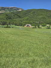 View of mountain backdrop with rural landscape and agricultural land