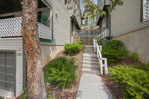 Exterior view of garage and stairs to front entry.