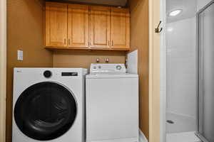 Washer and dryer with upper cabinetry.