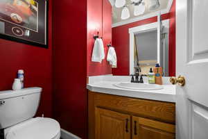 Half bathroom featuring vanity and crown molding.