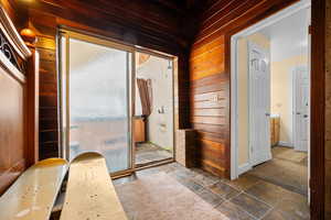 Sliding glass door to exterior hot tub.