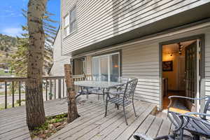 Wooden deck featuring outdoor dining.