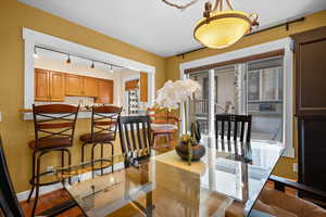 Dining room featuring granite countertop bar, and sliding glass door to additional outdoor dining.