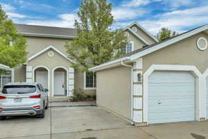 Traditional home featuring stucco siding