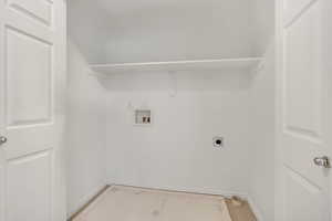 Laundry area with hookup for a washing machine, hookup for an electric dryer, and light carpet