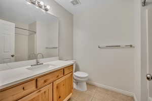 Full bath with vanity and light tile patterned floors