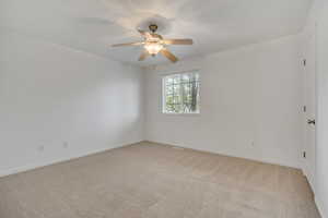Unfurnished room with light carpet and ceiling fan