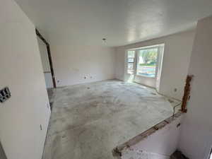 Unfurnished room with unfinished concrete floors