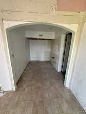 Hallway featuring arched walkways