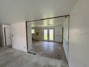 Empty room featuring french doors