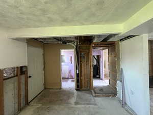 Miscellaneous room featuring concrete floors and a textured ceiling