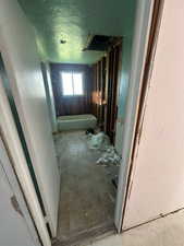 Hallway featuring a textured ceiling