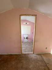 Corridor featuring vaulted ceiling