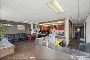 Interior space with open floor plan and dark countertops