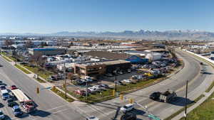 Drone / aerial view of a mountain backdrop and an industrial area