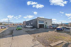 View of outdoor structure featuring uncovered parking