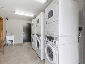 Communal laundry room with stacked washer / dryer and washing machine and clothes dryer