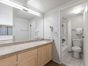 Full bath with vanity, shower / bath combination with curtain, and light tile patterned flooring