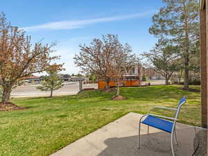 View of green lawn with a residential view