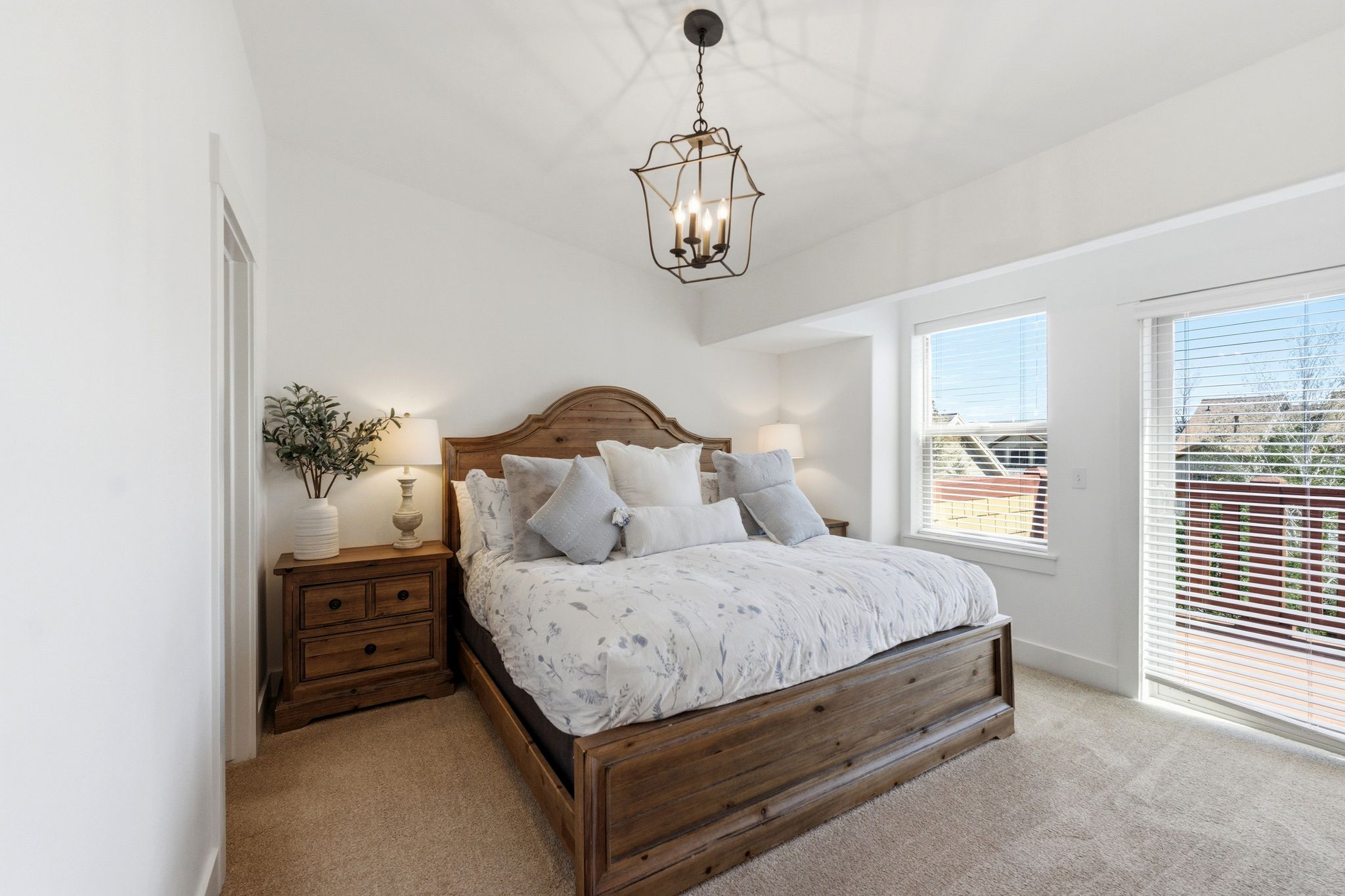 Carpeted bedroom featuring baseboards and hanging lights