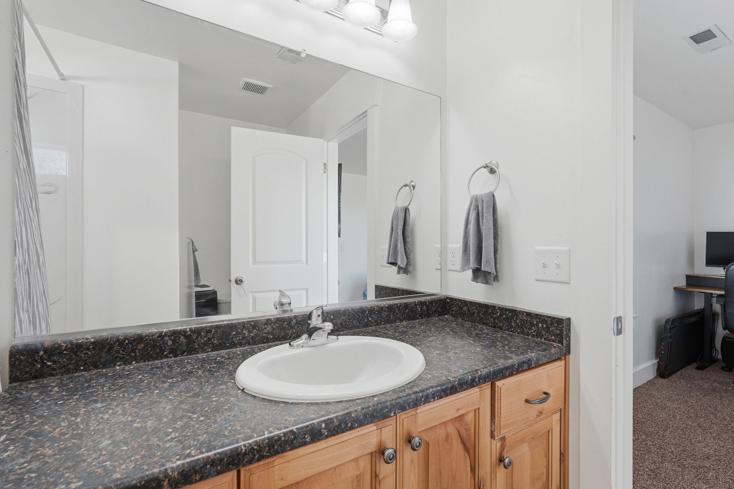Bathroom with vanity and carpet floors