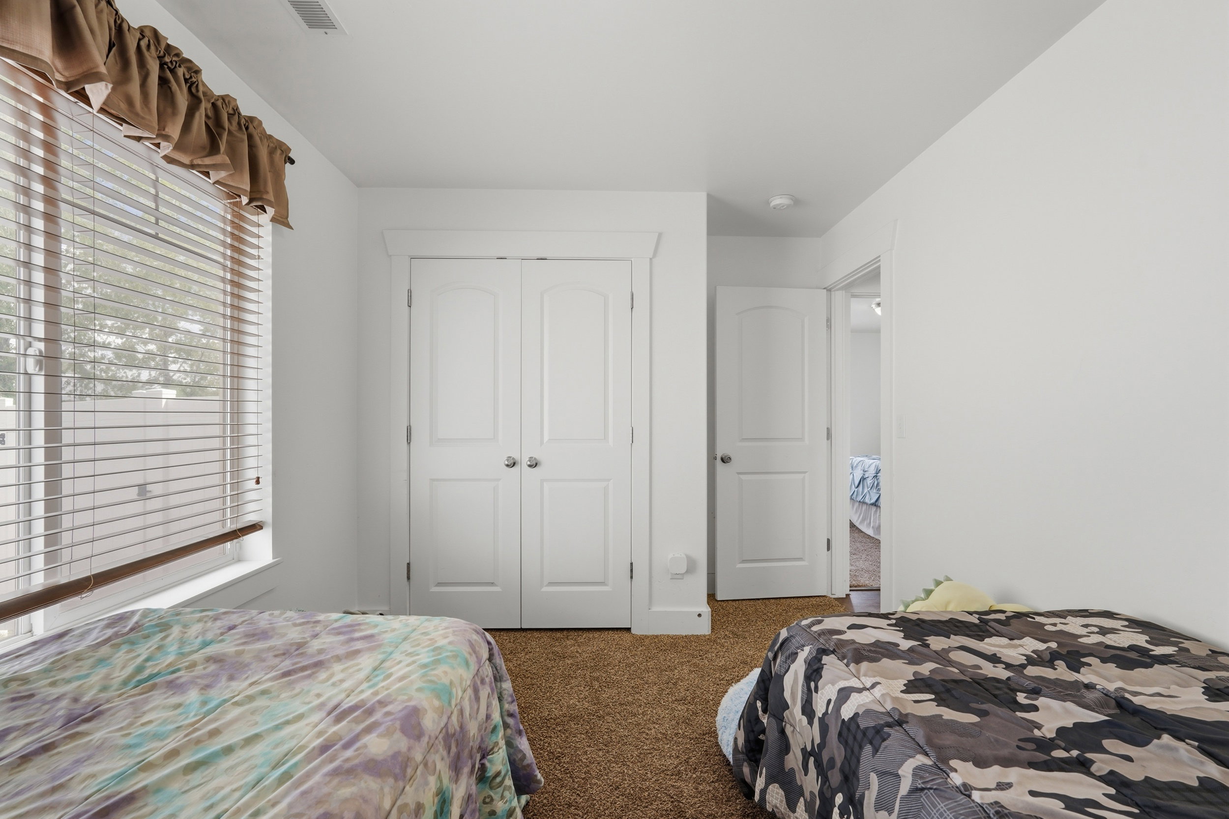 Bedroom with carpet flooring and a closet