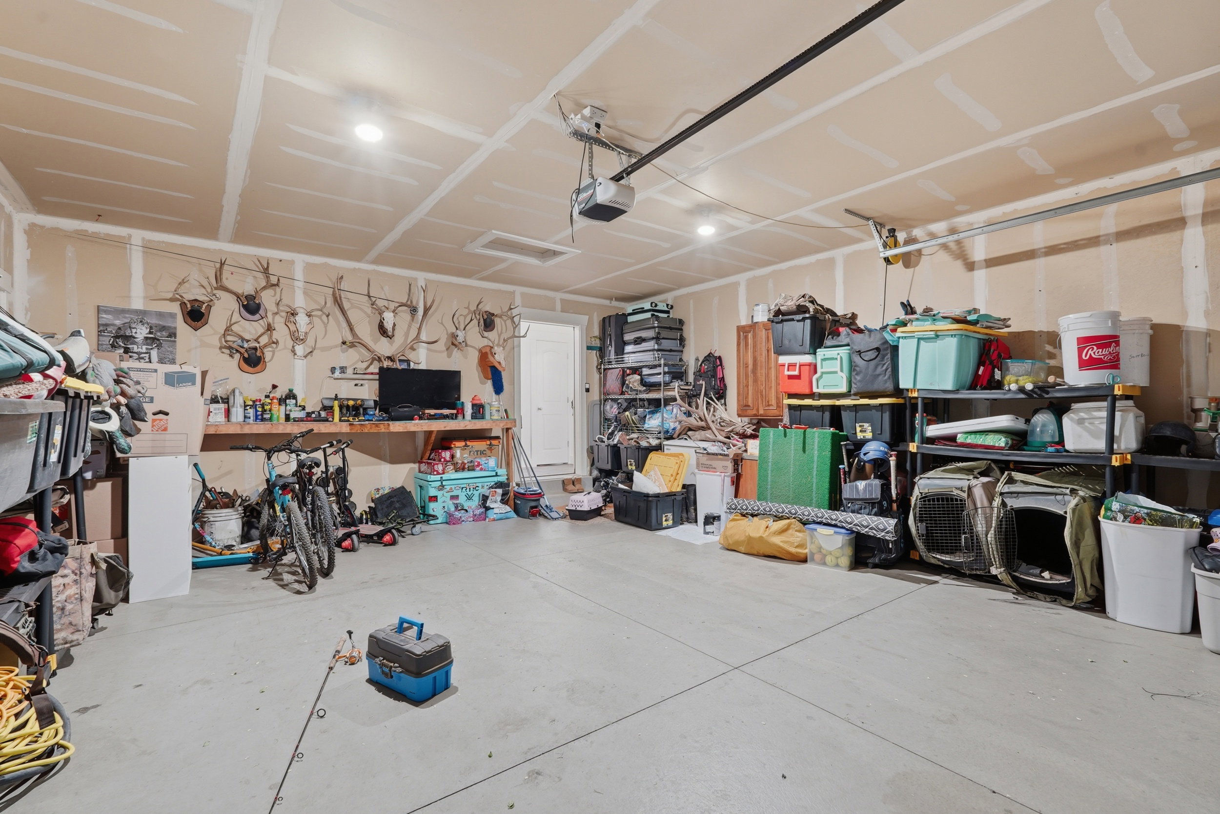 Garage featuring a workshop area and a garage door opener