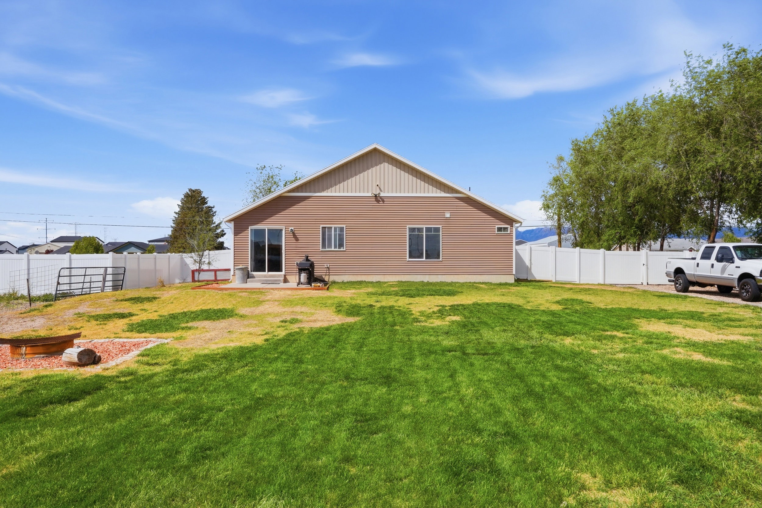 Back of property with a fenced backyard