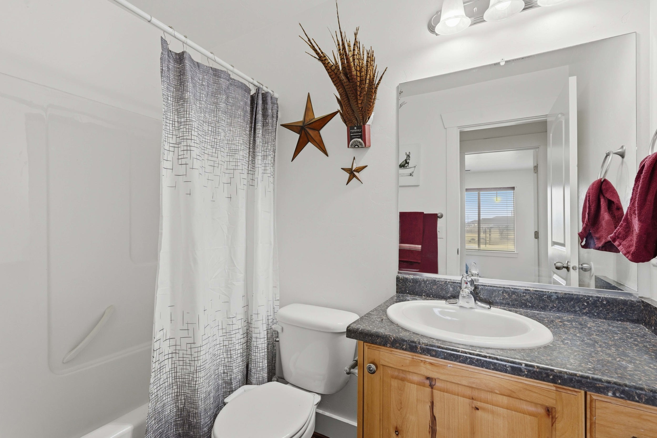 Full bath featuring vanity and shower / bath combination with curtain