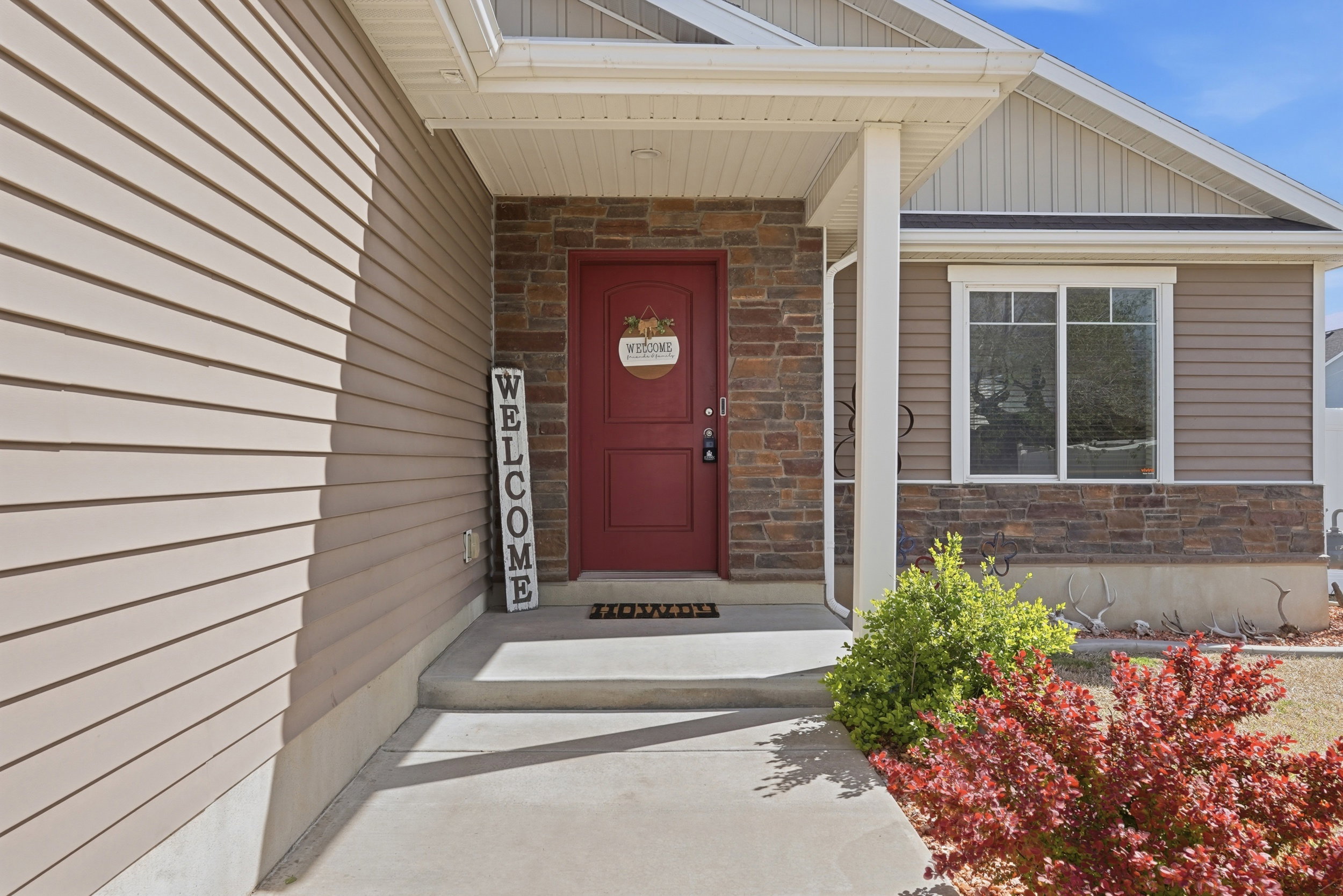 View of exterior entry featuring stone siding and board and batten siding