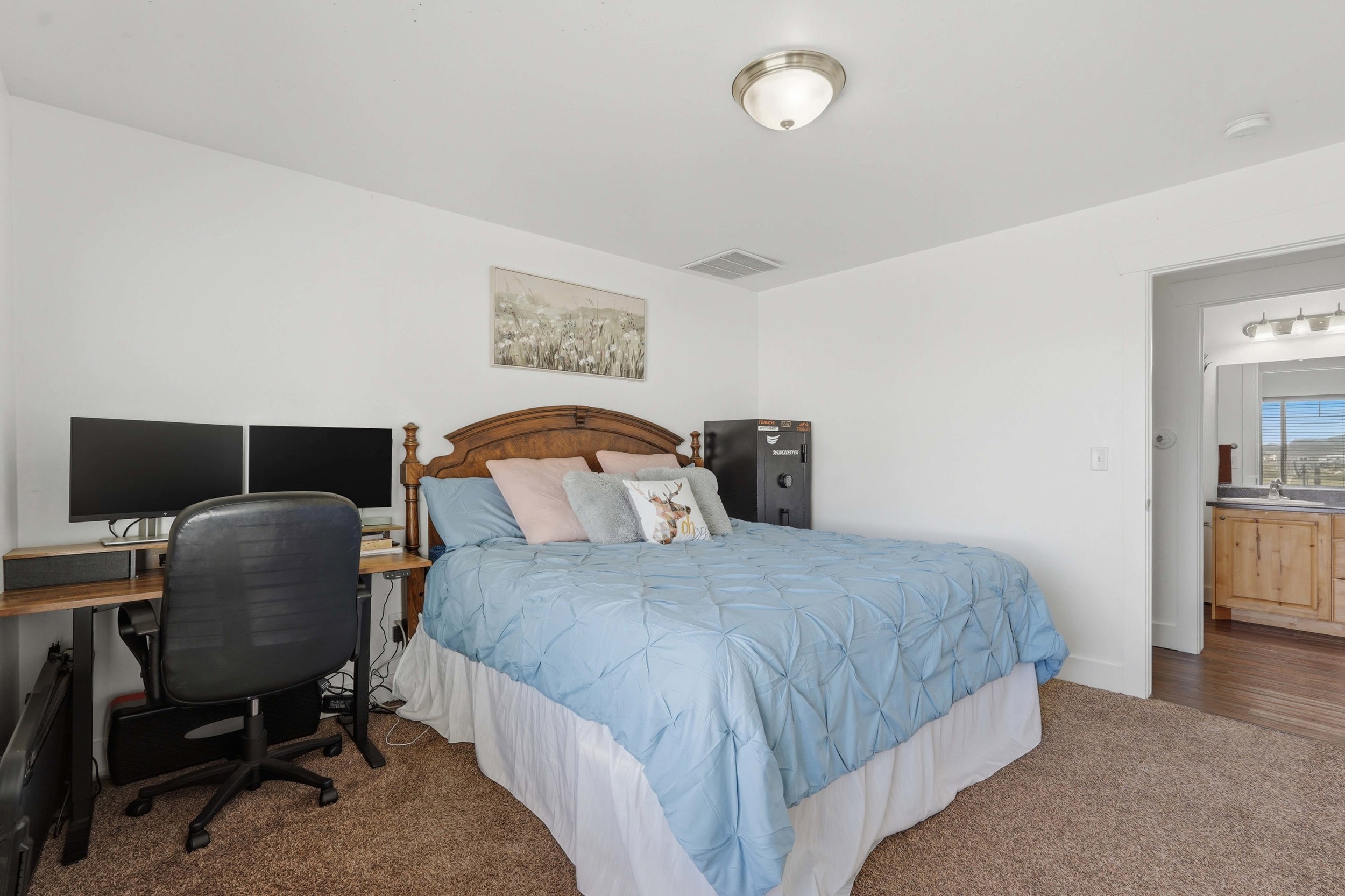 Bedroom with a desk and carpet floors