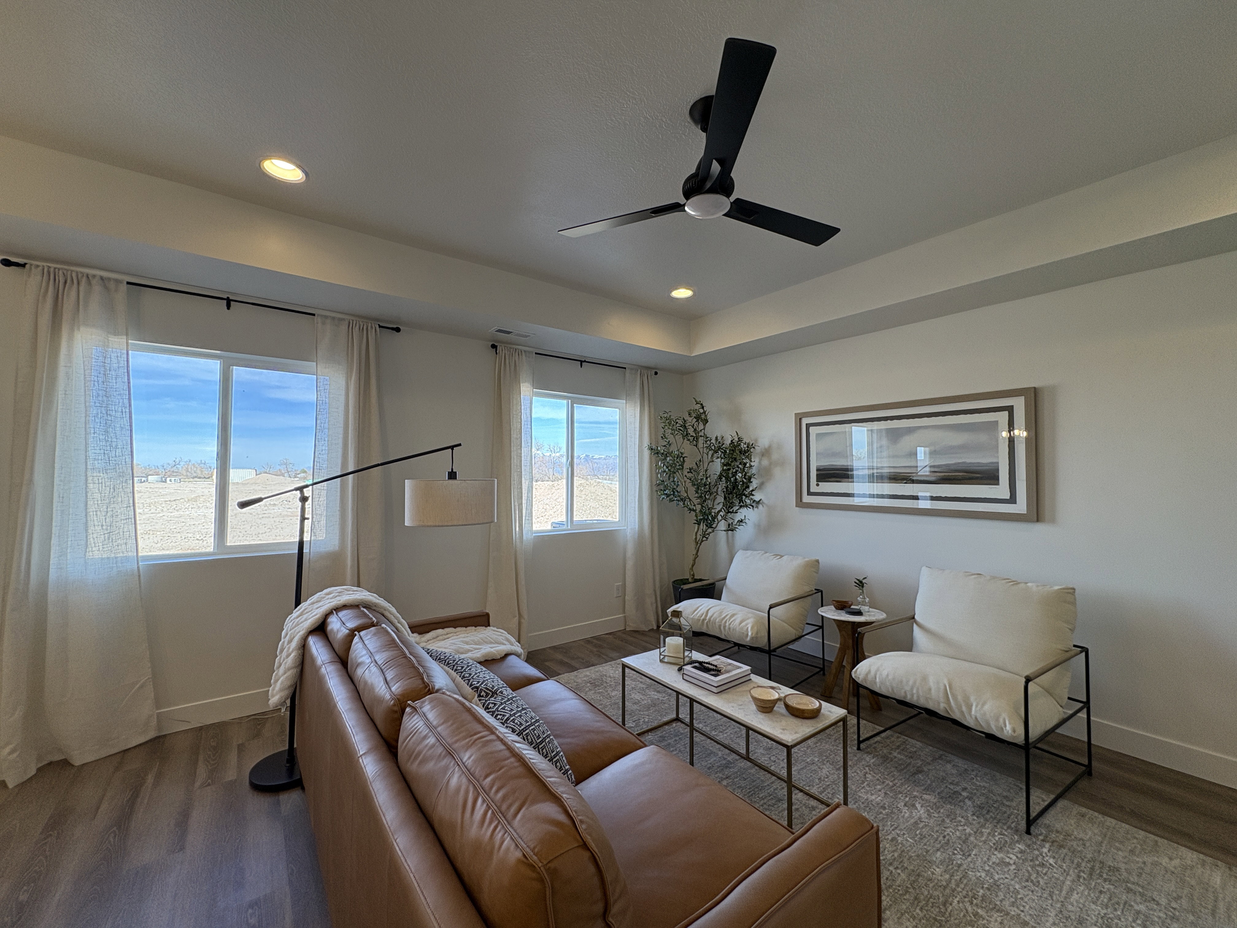 Living room with dark wood-style flooring, ceiling fan, and recessed lighting
