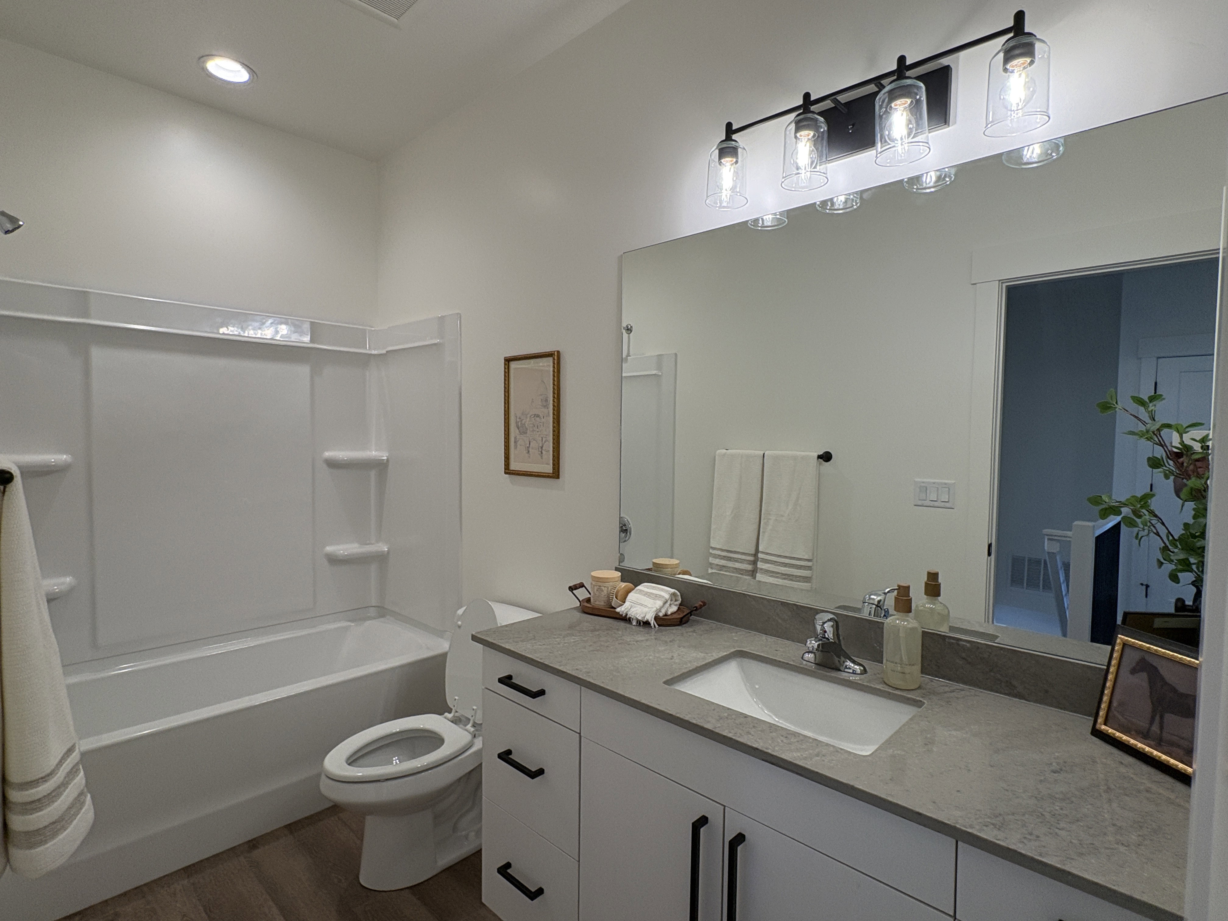 Full bathroom with vanity, dark wood finished floors, shower / tub combination, and recessed lighting