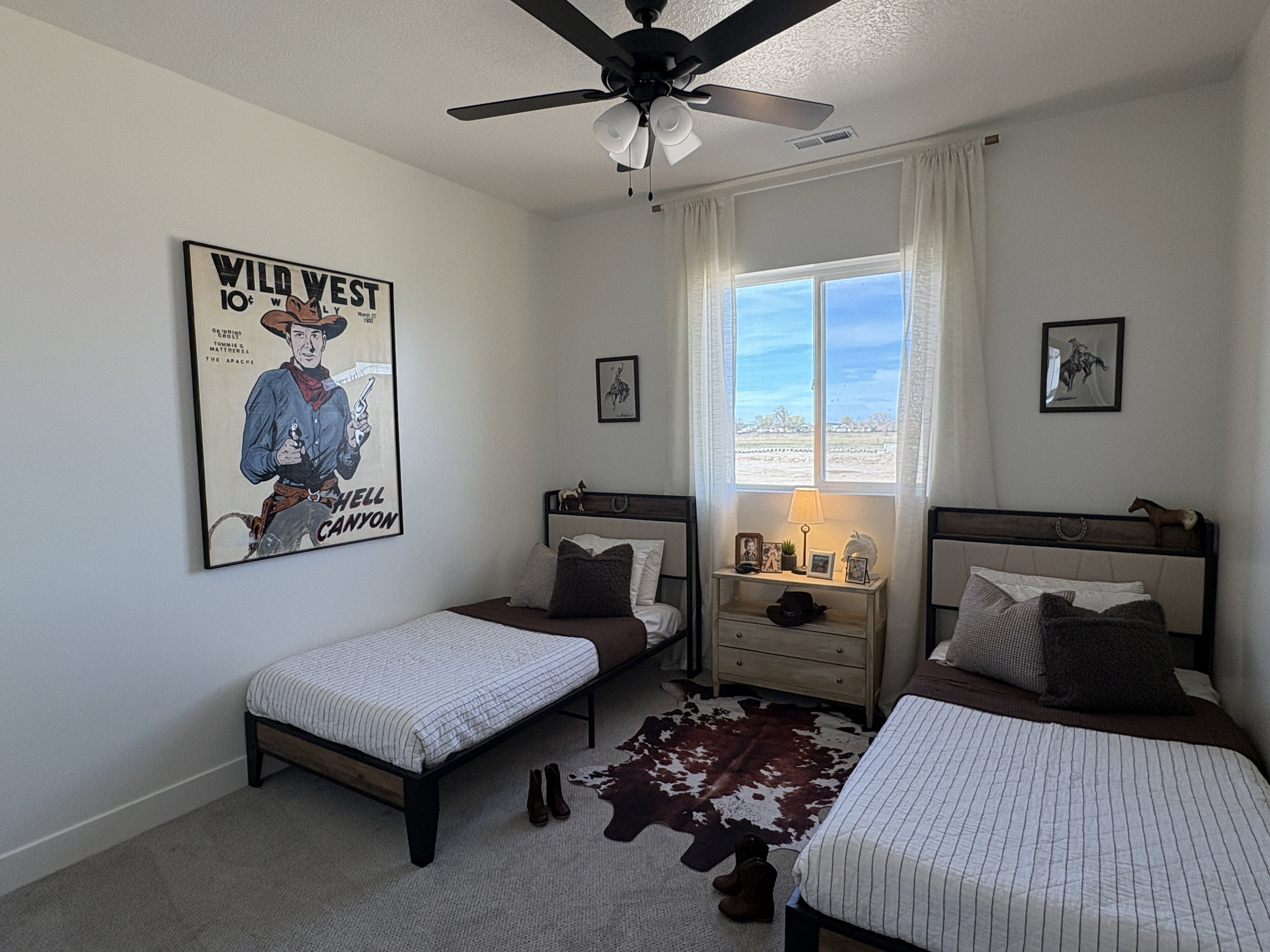 Carpeted bedroom with ceiling fan and baseboards