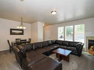 Open-concept living space featuring neutral-toned walls and carpet flooring