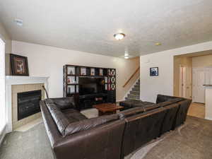 Living area featuring a corner fireplace with a tile surround and white mantel