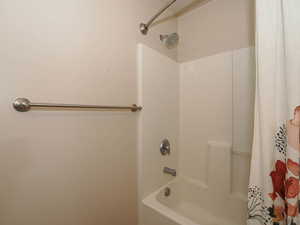 Tub/shower combination featuring a white surround