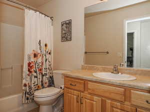 Bathroom featuring a light-toned vanity with an integrated sink and chrome faucet