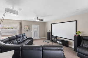 Living room with light colored carpet and a ceiling fan