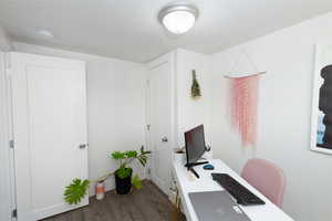 Bedroom used as home office featuring dark wood finished floors.