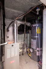 Utility room featuring water heater and Central Air.