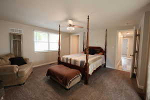 Carpeted bedroom with baseboards and ceiling fan