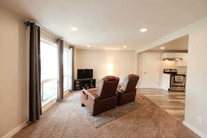 Living room with light carpet and recessed lighting