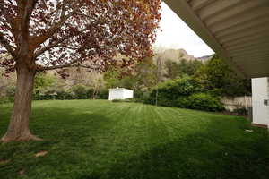 View of yard featuring a storage unit