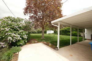 View of patio with a shed