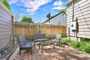 Fenced backyard with a patio and outdoor seating