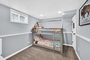 Bedroom featuring dark carpet and recessed lighting