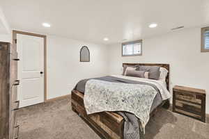 Bedroom featuring light carpet and recessed lighting