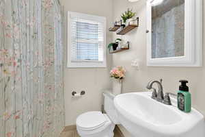 Full bathroom featuring curtained shower