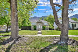 View of front of home with a mountain view and a shingled roof